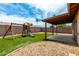 Outdoor patio and playset area with gravel and artificial turf at 2551 E Harmony Ave, Mesa, AZ 85204