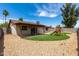 Large backyard with artificial grass, gravel, and patio at 2551 E Harmony Ave, Mesa, AZ 85204