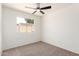 Bright bedroom featuring a ceiling fan and a window with a backyard view at 2551 E Harmony Ave, Mesa, AZ 85204