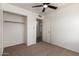 Bedroom features a closet and ceiling fan for comfort at 2551 E Harmony Ave, Mesa, AZ 85204