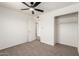 Bedroom with neutral carpeting, ceiling fan and closet at 2551 E Harmony Ave, Mesa, AZ 85204