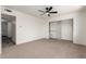 Neutral bedroom with carpeting, ceiling fan, and closet with sliding doors and built-in shelving at 2551 E Harmony Ave, Mesa, AZ 85204