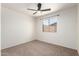 Bedroom features a ceiling fan and a window overlooking the yard at 2551 E Harmony Ave, Mesa, AZ 85204