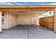 Attached car port featuring direct access and partial fencing for added privacy and security at 2551 E Harmony Ave, Mesa, AZ 85204