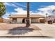 Charming single-story home with a front yard featuring desert landscaping and an attached carport at 2551 E Harmony Ave, Mesa, AZ 85204