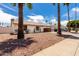 Charming single-story home with a front yard featuring desert landscaping and an attached carport at 2551 E Harmony Ave, Mesa, AZ 85204