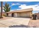 Charming single-story home with a front yard featuring desert landscaping and an attached carport at 2551 E Harmony Ave, Mesa, AZ 85204