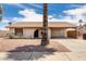 Charming single-story home with a front yard featuring desert landscaping and an attached carport at 2551 E Harmony Ave, Mesa, AZ 85204