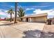Charming single-story home with a front yard featuring desert landscaping and an attached carport at 2551 E Harmony Ave, Mesa, AZ 85204