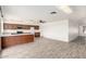 Bright, open-concept kitchen with wood-style flooring and matching wood cabinets with bright countertops at 2551 E Harmony Ave, Mesa, AZ 85204