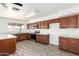 Spacious kitchen featuring wood cabinets, marble countertops, and stainless steel appliances at 2551 E Harmony Ave, Mesa, AZ 85204