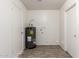 Neutral laundry room with wood-look floors and water heater at 2551 E Harmony Ave, Mesa, AZ 85204