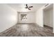 Bright living room featuring wood-look flooring, neutral walls and modern ceiling fan at 2551 E Harmony Ave, Mesa, AZ 85204