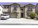 Inviting two-story home with a neutral-toned exterior, arched windows, attached two-car garage, and well-kept landscaping at 25574 W Lynne Ln, Buckeye, AZ 85326