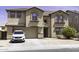 Beautiful two-story home with a two-car garage, desert landscaping, and a welcoming front entrance with unique architectural details at 25574 W Lynne Ln, Buckeye, AZ 85326