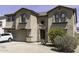 Attractive two-story home with arched windows, an attached garage, and a low-maintenance desert landscaped front yard at 25574 W Lynne Ln, Buckeye, AZ 85326