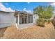 Exterior view of a screened porch and the gravel-filled backyard with landscaping at 2801 N 10Th St, Phoenix, AZ 85006