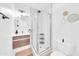 This bathroom is equipped with a modern vanity, decorative mirrors, and a tiled shower with a glass door at 2801 N 10Th St, Phoenix, AZ 85006