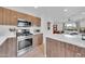 This kitchen has sleek, wood cabinets, an island, and stainless steel appliances for modern living at 2801 N 10Th St, Phoenix, AZ 85006