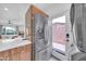 This kitchen features modern stainless steel appliances, wood cabinetry, and a walk-out door at 2801 N 10Th St, Phoenix, AZ 85006