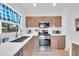 This modern kitchen features stainless steel appliances, wooden cabinetry, and sleek countertops at 2801 N 10Th St, Phoenix, AZ 85006