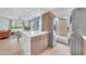 This open floor plan reveals a kitchen with wood cabinets, an island, and stainless steel appliances at 2801 N 10Th St, Phoenix, AZ 85006