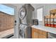 A clean laundry area features stacked washer and dryer units and quick access to the back yard at 2801 N 10Th St, Phoenix, AZ 85006