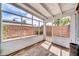 A screened porch with a brick floor and walls that look out onto the yard at 2801 N 10Th St, Phoenix, AZ 85006