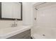 Modern bathroom features updated vanity, framed mirror, and a shower-tub combo at 3017 N 46Th Dr, Phoenix, AZ 85031