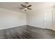 The bedroom features modern wood flooring, a ceiling fan, and two closet doors at 3017 N 46Th Dr, Phoenix, AZ 85031