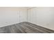 A bright bedroom offering modern flooring, white walls and doors, and large closets at 3017 N 46Th Dr, Phoenix, AZ 85031