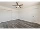 Cozy bedroom with wood-look flooring, ample closet space, and neutral walls at 3017 N 46Th Dr, Phoenix, AZ 85031
