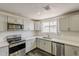 Modern kitchen boasts stainless steel appliances, granite countertops, and a stylish backsplash at 3017 N 46Th Dr, Phoenix, AZ 85031