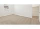 Bright bedroom featuring neutral carpet, white walls, and a closet at 37114 W La Paz St, Maricopa, AZ 85138