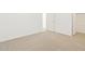 Bright bedroom featuring neutral carpet, white walls, and a closet at 37114 W La Paz St, Maricopa, AZ 85138