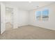 Bedroom with neutral carpet, white walls, and a window for natural light at 37114 W La Paz St, Maricopa, AZ 85138