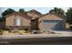 Charming single-Gathering home with stone accents, a two-car garage, and desert landscaping at 37114 W La Paz St, Maricopa, AZ 85138
