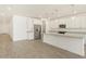 Bright, open kitchen features white cabinets, stainless steel appliances, granite countertops, and pendant lighting at 37114 W La Paz St, Maricopa, AZ 85138