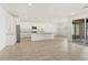 Open concept kitchen with stainless steel appliances, granite countertops, and bright, modern finishes at 37114 W La Paz St, Maricopa, AZ 85138