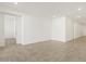 Spacious living room featuring neutral paint colors, tile floors, and an open doorway at 37114 W La Paz St, Maricopa, AZ 85138