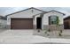 Charming single-story home featuring a well-manicured yard and a two-car garage with neutral color palette at 37154 W Prado St, Maricopa, AZ 85138