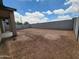 The backyard has a cinderblock wall and view of home under a blue sky with puffy clouds at 37371 W San Sisto Ave, Maricopa, AZ 85138