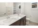 Bright bathroom featuring double sinks, a large mirror, and a window providing natural light and a clean design at 37371 W San Sisto Ave, Maricopa, AZ 85138