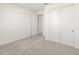 Bedroom with a double door closet and a door leading to an additional room at 37371 W San Sisto Ave, Maricopa, AZ 85138