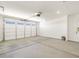 Spacious garage with neutral color scheme, lighting, and automatic door at 37371 W San Sisto Ave, Maricopa, AZ 85138