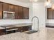 New kitchen featuring granite counters, stainless steel appliances, and dark wood cabinets at 37371 W San Sisto Ave, Maricopa, AZ 85138