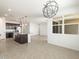 Open-concept kitchen boasts stainless appliances, granite counters, and large island with pendant lighting at 37371 W San Sisto Ave, Maricopa, AZ 85138