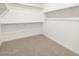 Spacious walk-in closet with carpet and multiple shelves for storage at 37371 W San Sisto Ave, Maricopa, AZ 85138