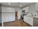 Updated kitchen with stainless steel appliances, white cabinets, and new countertops at 3841 N 21St Ave, Phoenix, AZ 85015