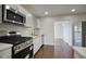 Modern kitchen featuring stainless steel appliances, white cabinets, and plenty of countertop space at 3841 N 21St Ave, Phoenix, AZ 85015